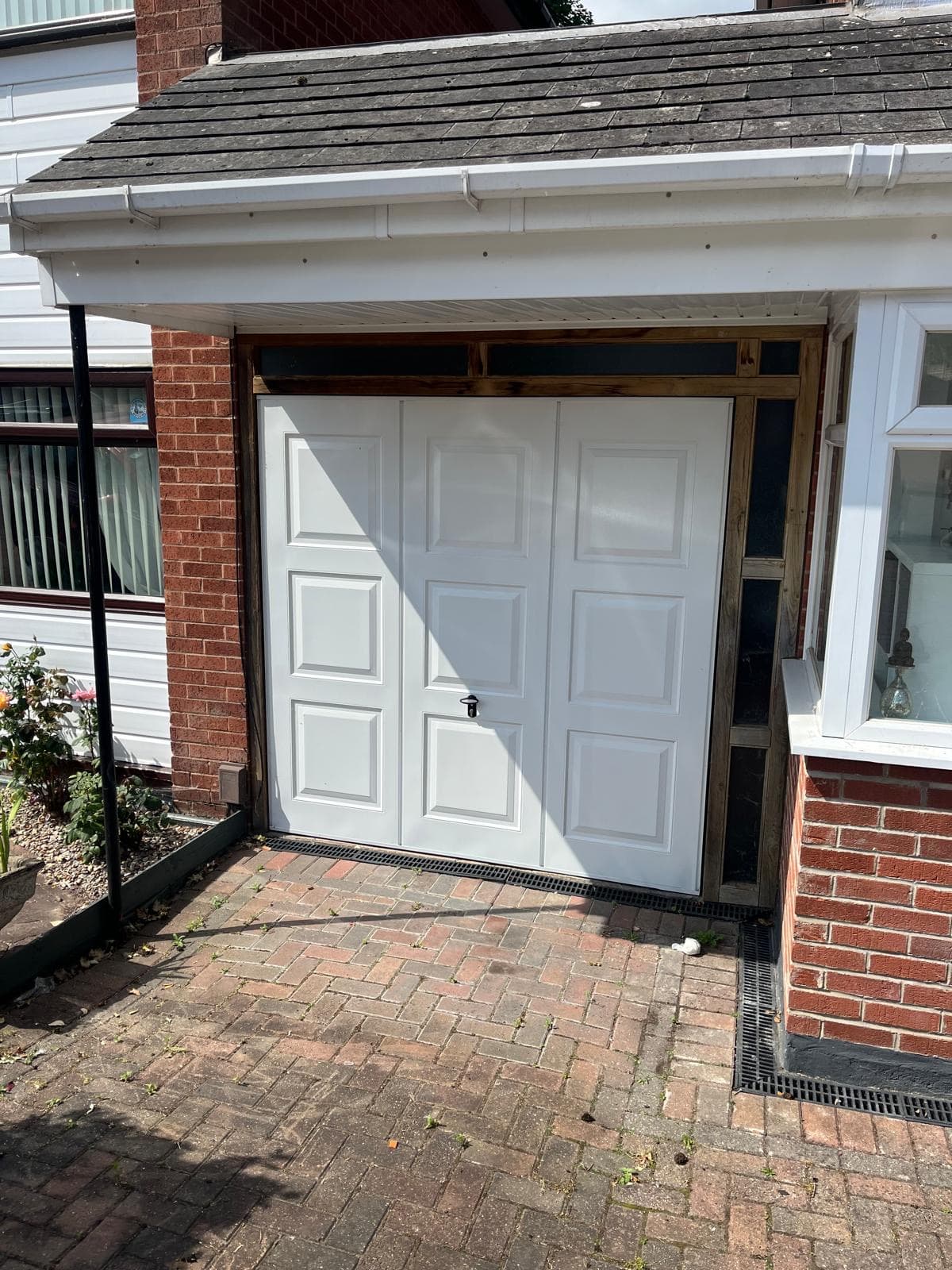 The same house before the conversion, with a white up-and-over garage door