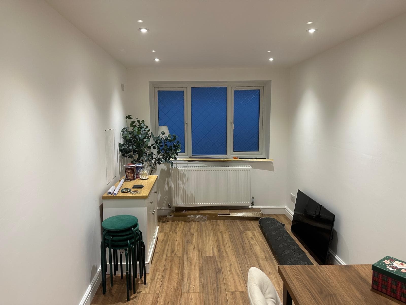 Our own finished garage conversion: the new window wall of the dining room, with a radiator beneath it and wood-effect flooring